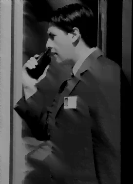 man holding a walkie talkie wearing a suit